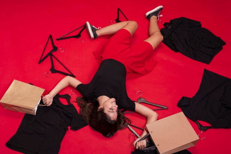 top-view-woman-staying-floor-with-her-new-clothes_23-2148302846